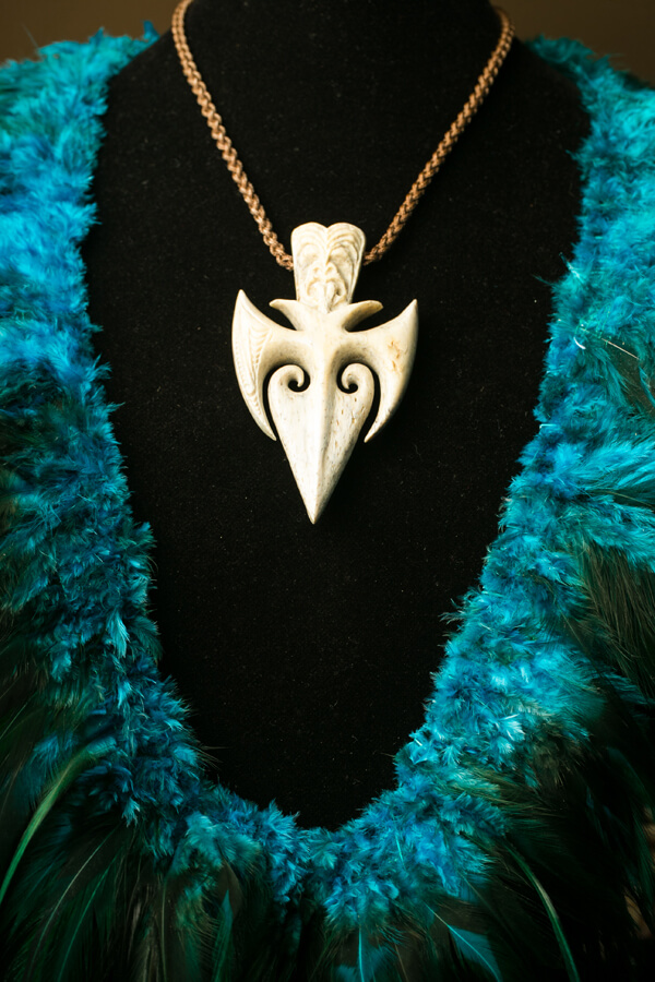 Hand-carved bone pendant on braided cord